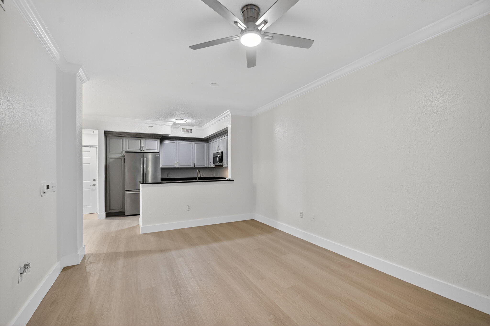 1 Renaissance Way, Unit 116 Boynton Beach, FL 33426 - Photo 12 of 34 a view of a kitchen with a sink and a refrigerator