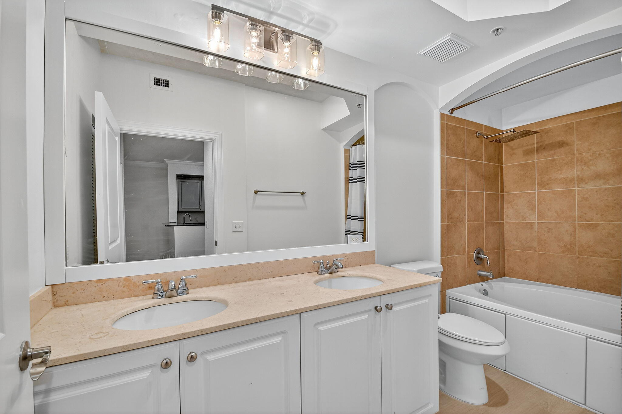 1 Renaissance Way, Unit 116 Boynton Beach, FL 33426 - Photo 13 of 34 a bathroom with a granite countertop sink a toilet and a mirror