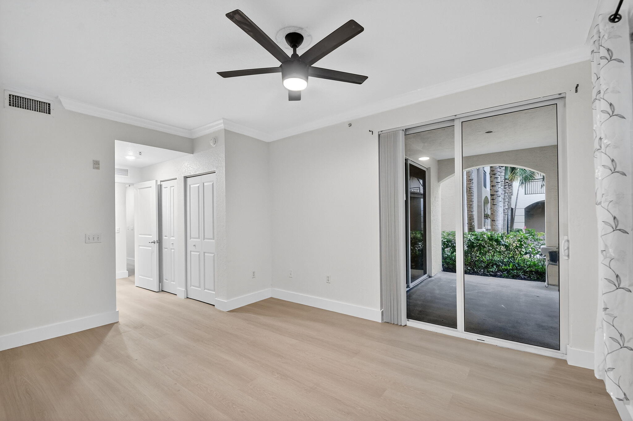 1 Renaissance Way, Unit 116 Boynton Beach, FL 33426 - Photo 17 of 34 an empty room with wooden floor and windows