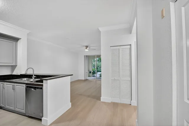 a kitchen with stainless steel appliances granite countertop a refrigerator a stove and a sink