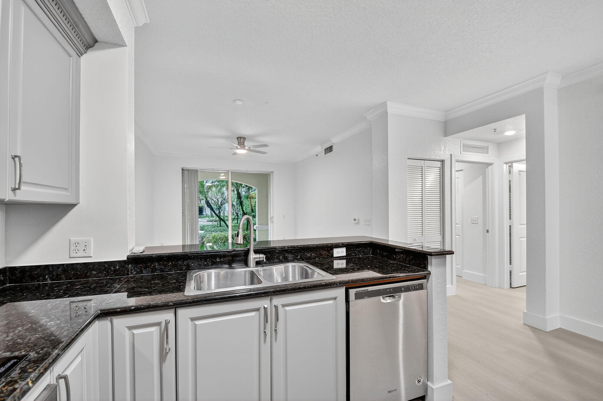 1 Renaissance Way, Unit 116 Boynton Beach, FL 33426 - Photo 8 of 34 a kitchen with granite countertop a sink and cabinets