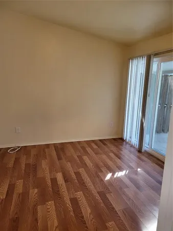 a view of an empty room and wooden floor