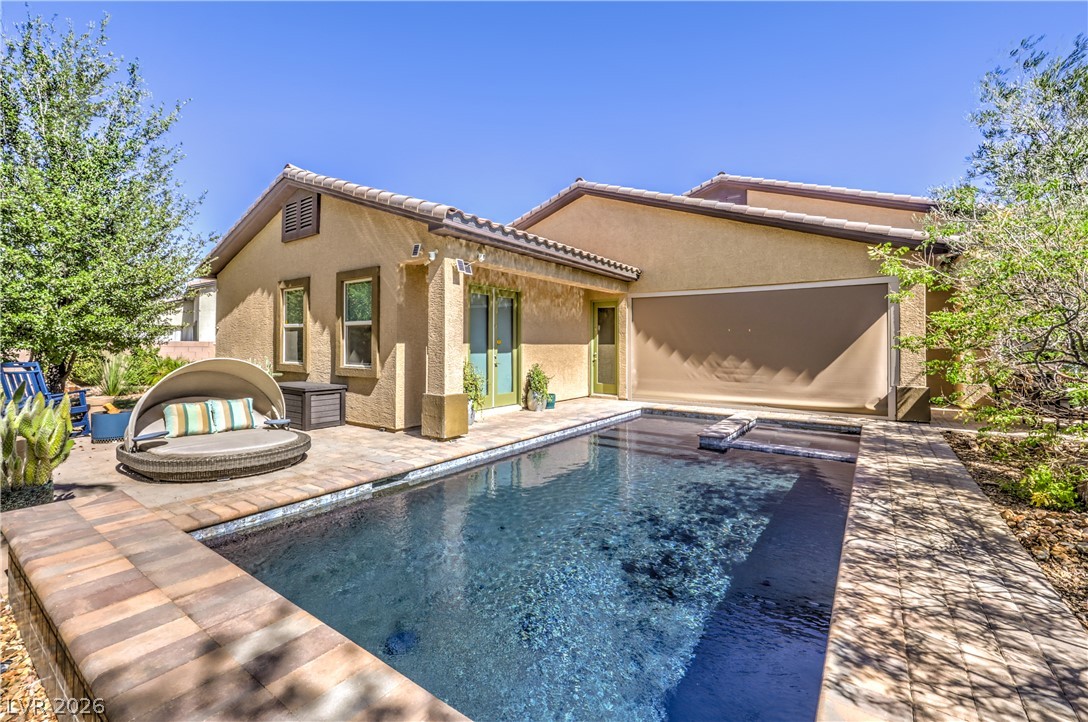 7119 Arabian Ridge Street Las Vegas, NV 89131 - Photo 47 of 73 An inviting backyard oasis offers a sparkling pool and sun loungers for ultimate relaxation.