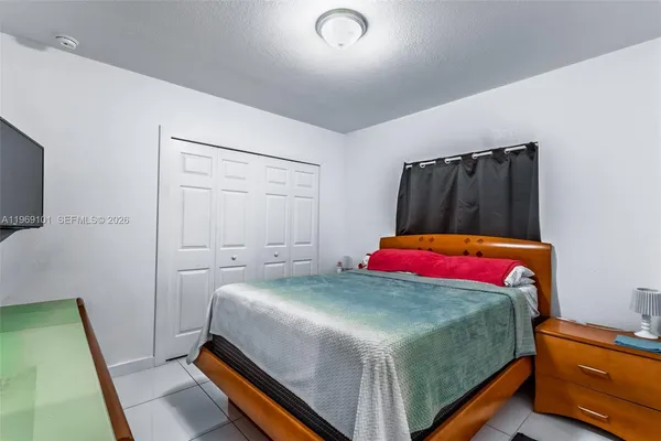 a bedroom with a bed and a mirror