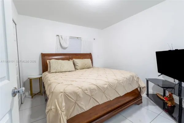 a bedroom with a bed and a chair in it