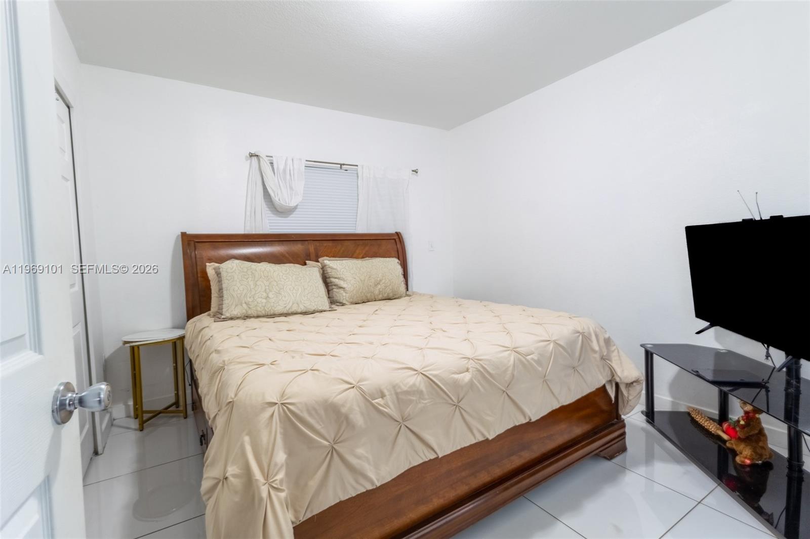 1998 Northwest 47th Street Miami, FL 33142 - Photo 16 of 17 a bedroom with a bed and a chair in it