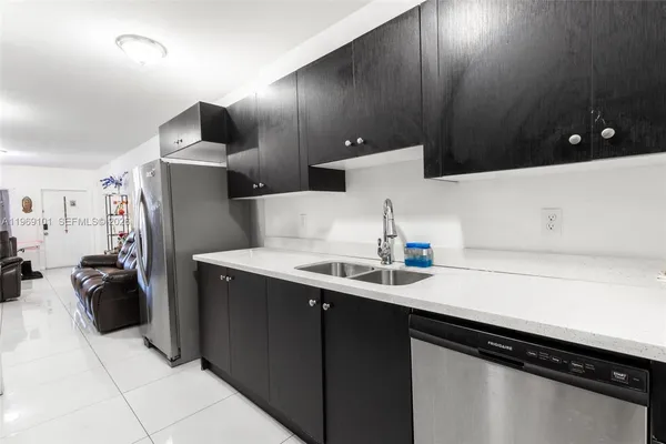 a kitchen with a sink and a refrigerator