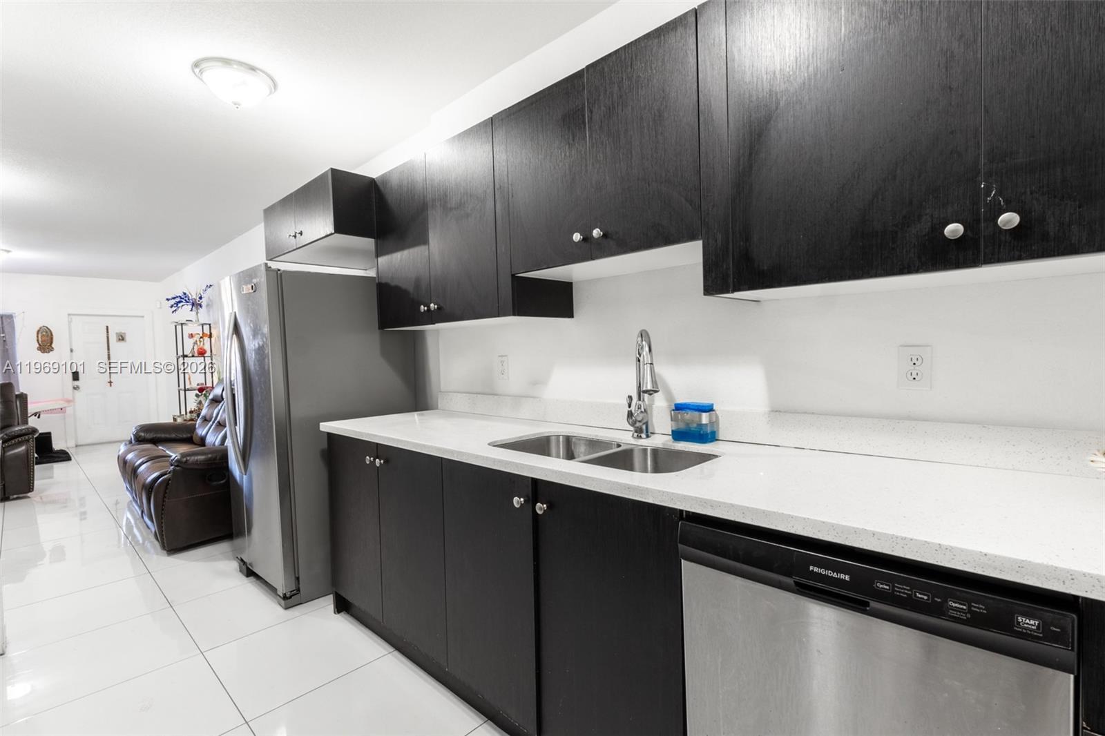 1998 Northwest 47th Street Miami, FL 33142 - Photo 4 of 17 a kitchen with a sink and a refrigerator