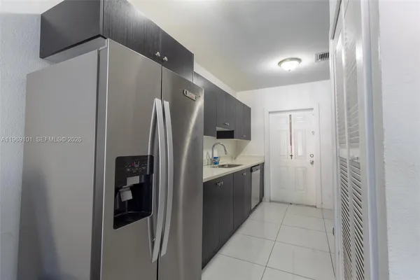 a kitchen with stainless steel appliances a refrigerator and a sink