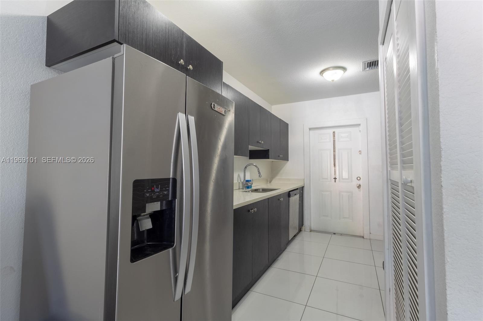 1998 Northwest 47th Street Miami, FL 33142 - Photo 6 of 17 a kitchen with stainless steel appliances a refrigerator and a sink