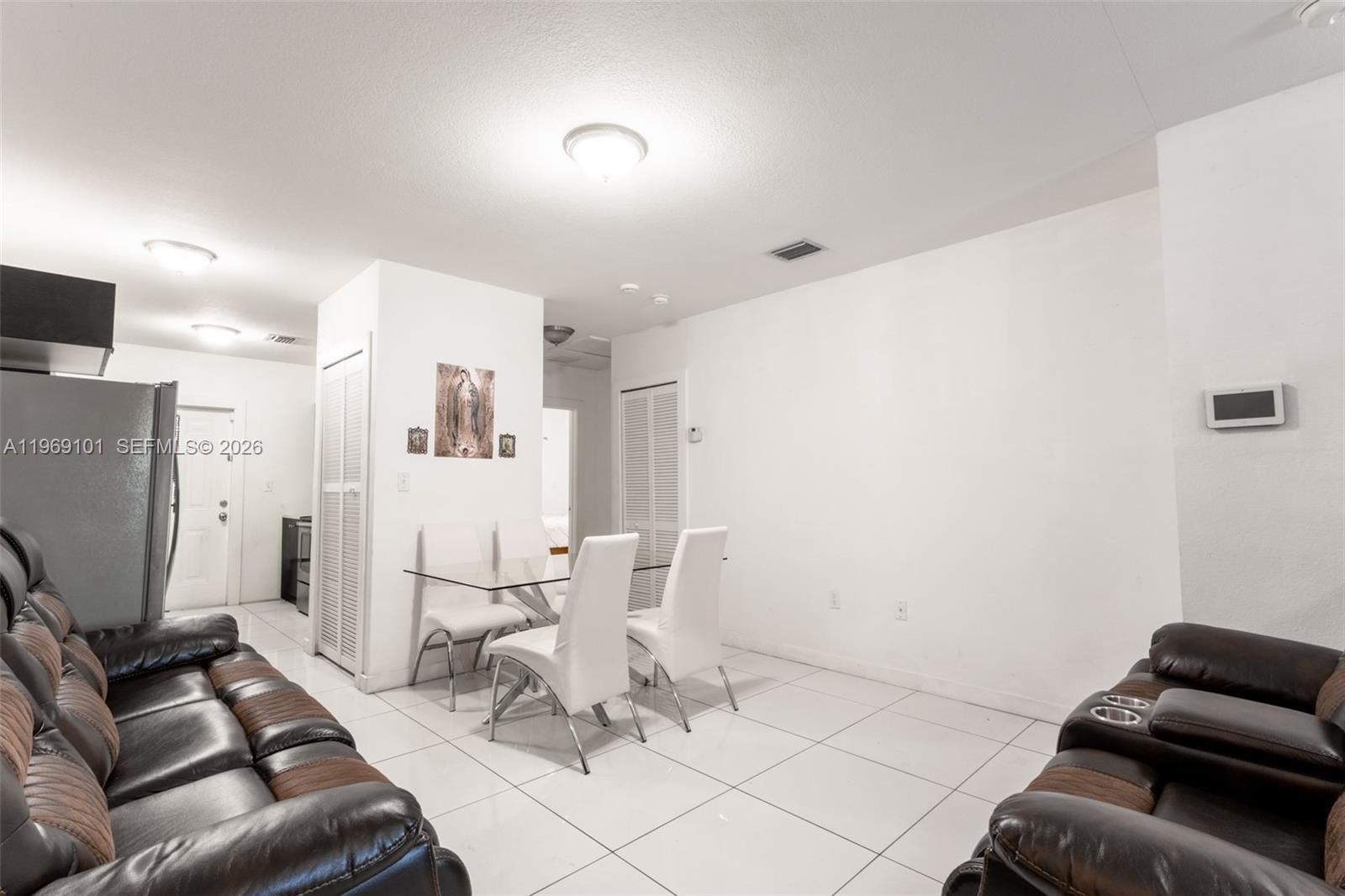 1998 Northwest 47th Street Miami, FL 33142 - Photo 9 of 17 a living room with furniture and a flat screen tv