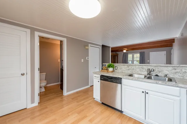 a kitchen with a sink and a stove top oven