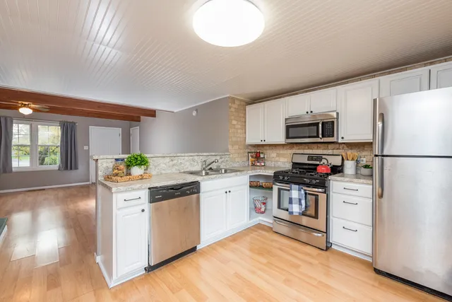 a kitchen with a refrigerator stove and sink