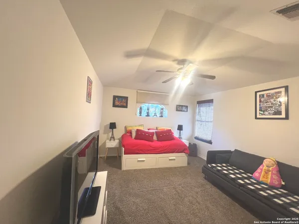 a bedroom with a bed and a couch