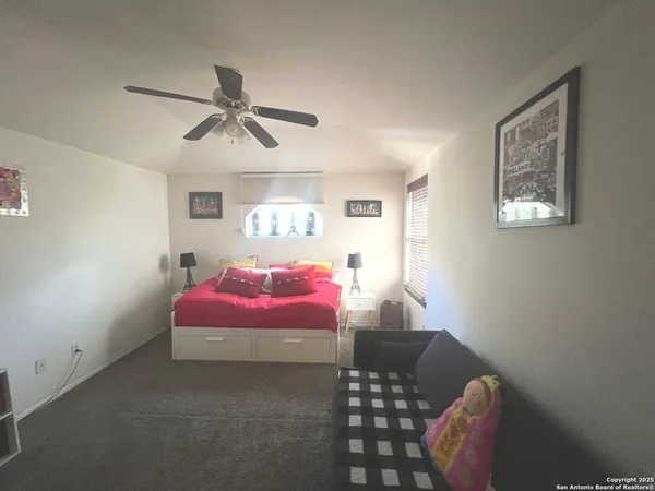 a bedroom with a bed and window