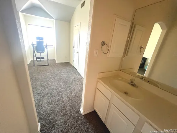 a bathroom with a sink a toilet and a mirror