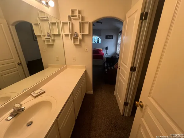 a bathroom with a sink and mirror