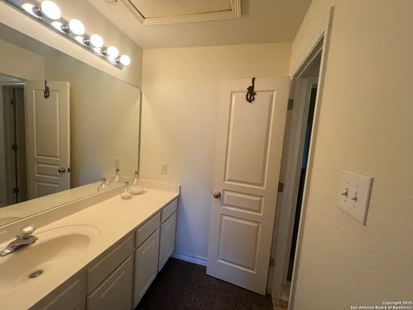 a bathroom with a double vanity sink and mirror