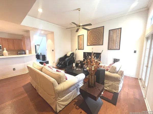 a living room with furniture and a chandelier