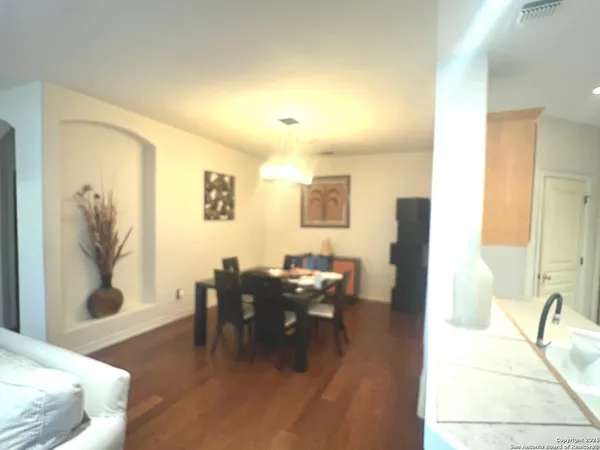 a dining room with furniture and wooden floor