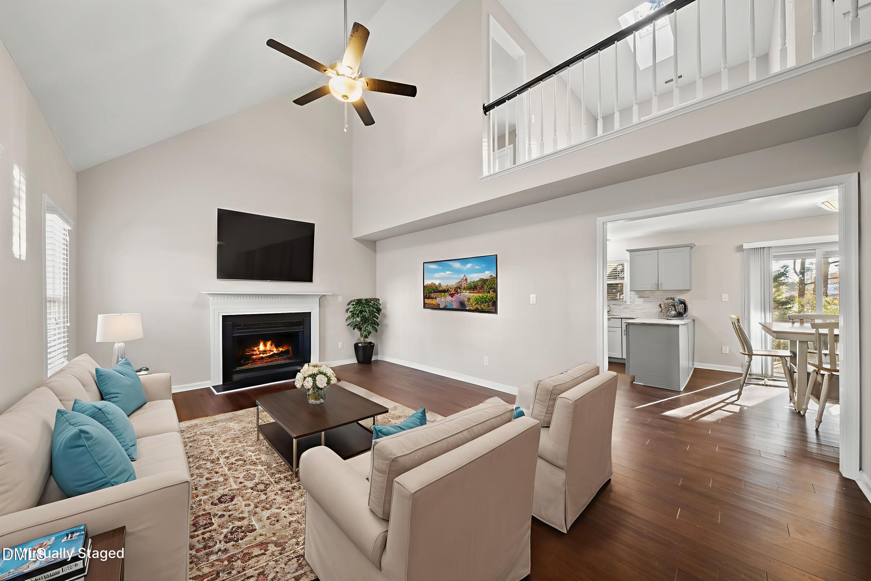 8324 Bellingham Circle Raleigh, NC 27615 - Photo 5 of 34 a living room with furniture a flat screen tv and a fireplace