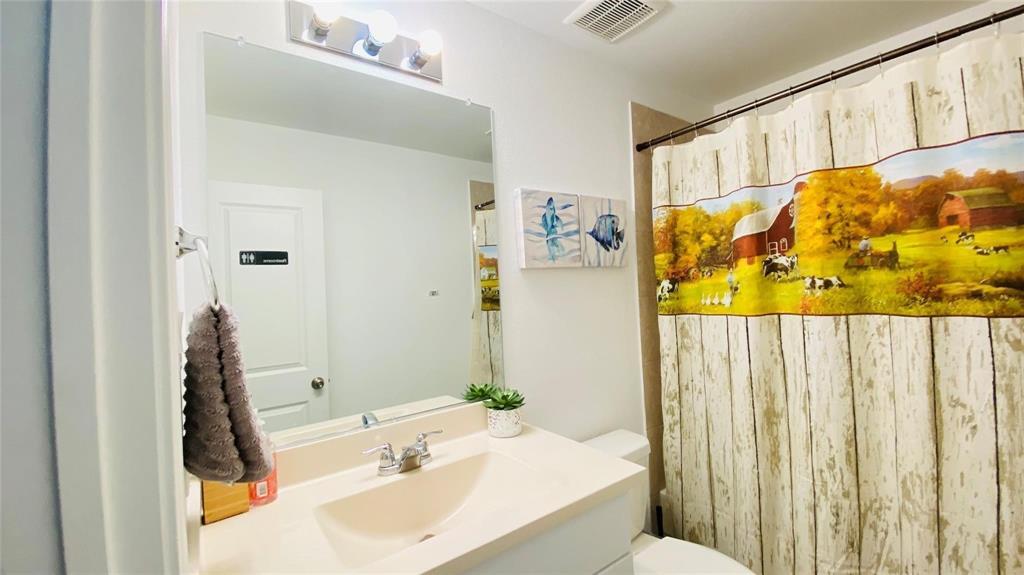 4612 Azurite Road Little Elm, TX 76227 - Photo 7 of 11 a bathroom with a sink and a mirror
