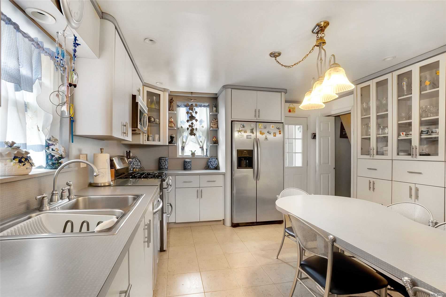 a kitchen with refrigerator cabinets and a sink