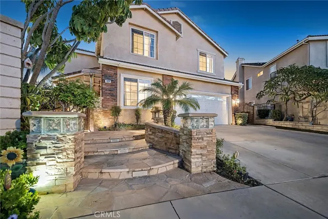 a front view of a house with a garden