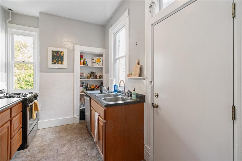 4123 Foster Street Pittsburgh, PA 15201 - Photo 12 of 31 a kitchen with sink cabinets and stove top oven
