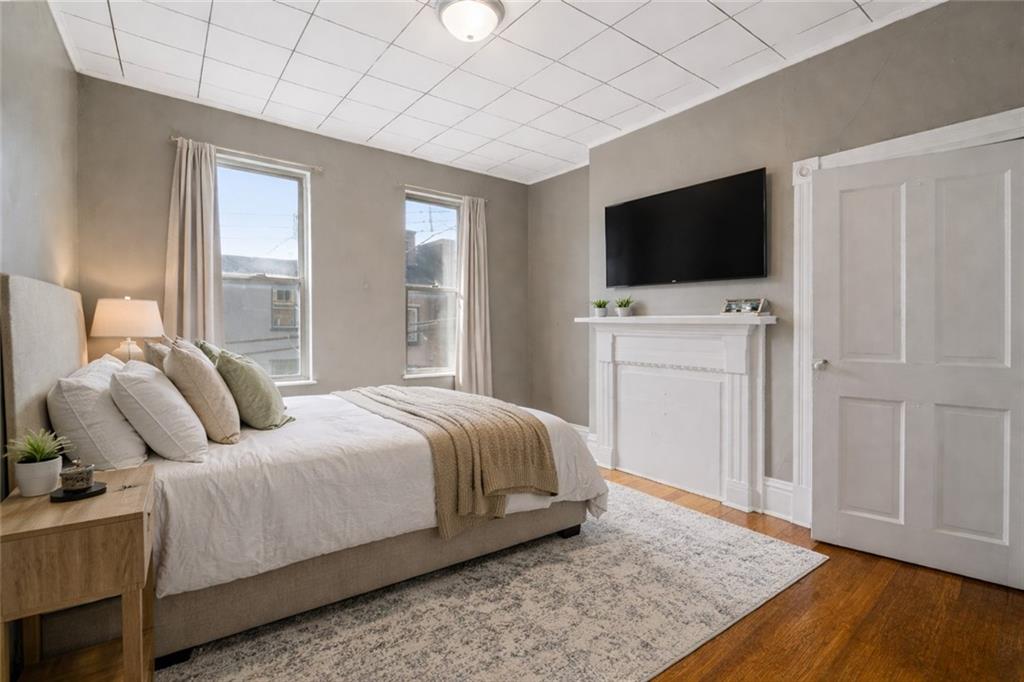 4123 Foster Street Pittsburgh, PA 15201 - Photo 17 of 31 a bedroom with a bed and a flat screen tv