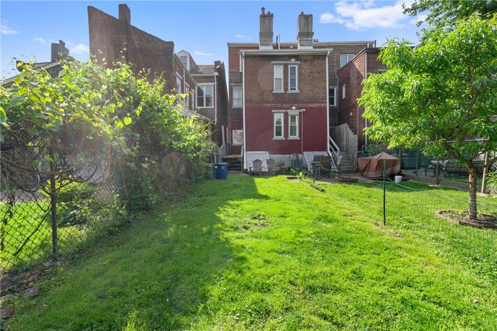 4123 Foster Street Pittsburgh, PA 15201 - Photo 21 of 31 a brick house with a yard in front of it