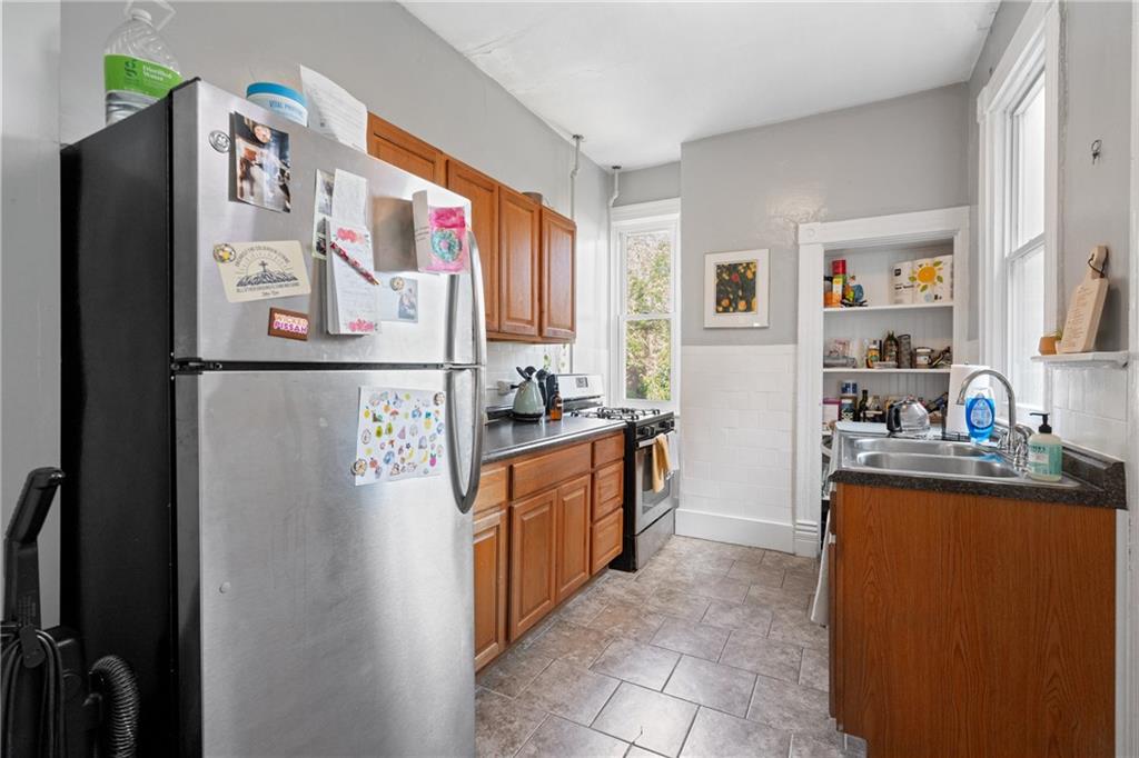 4123 Foster Street Pittsburgh, PA 15201 - Photo 8 of 31 a kitchen with stainless steel appliances granite countertop a refrigerator and a stove