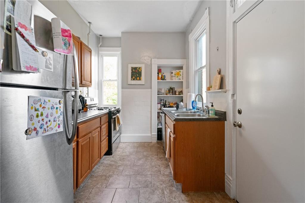 4123 Foster Street Pittsburgh, PA 15201 - Photo 9 of 31 a view of a kitchen with fridge and workspace