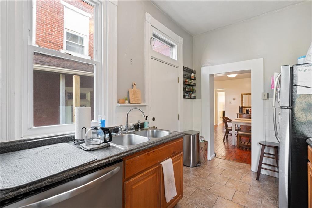 4123 Foster Street Pittsburgh, PA 15201 - Photo 10 of 31 a kitchen with stainless steel appliances sink refrigerator and window