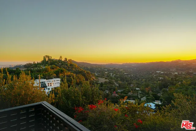 a view of a house with a backyard and garden