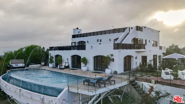 a front view of house with yard and outdoor seating