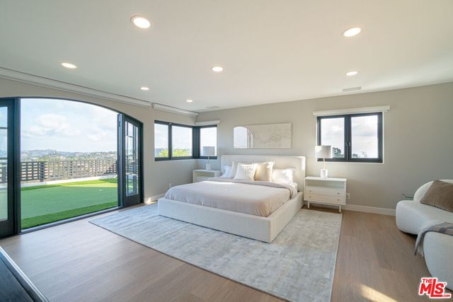 a spacious bathroom with a tub and a large window