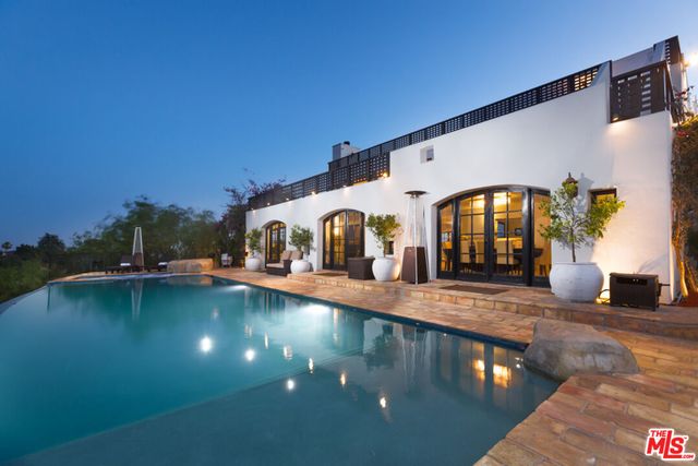 a view of swimming pool with outdoor seating