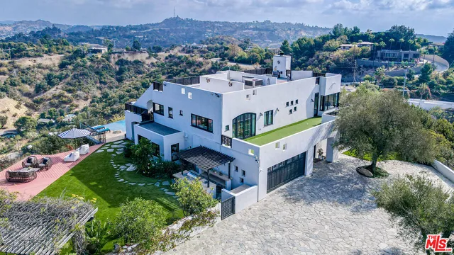 a view of a city with lush green forest