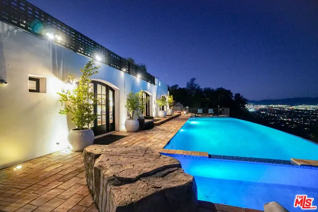 a room with pool table and windows