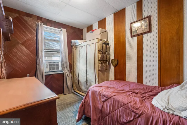 a bed sitting in a bedroom next to a window