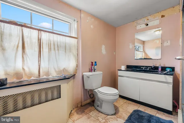 a bathroom with a toilet sink and mirror