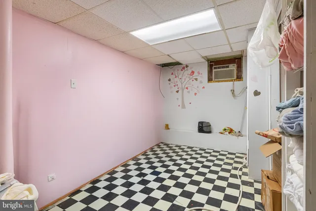a bathroom with a black white checkered floor and a shower curtain