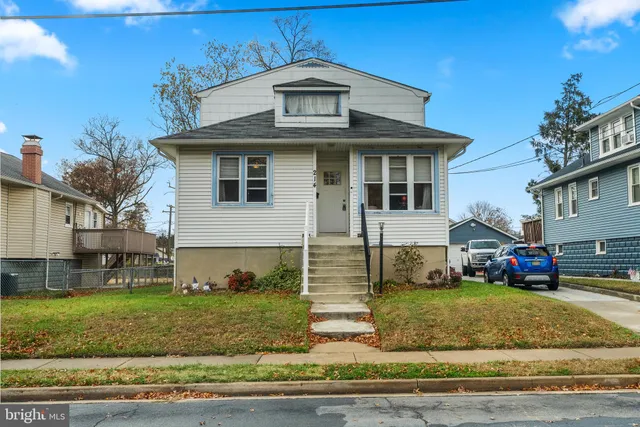 a view of a white house with large windows and yard