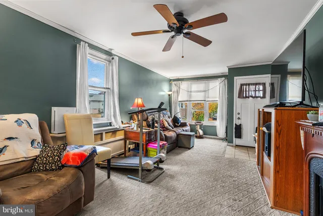 a living room with furniture gym equipment and a large window