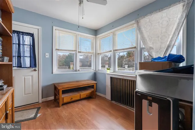 a living room with a bed furniture and a window