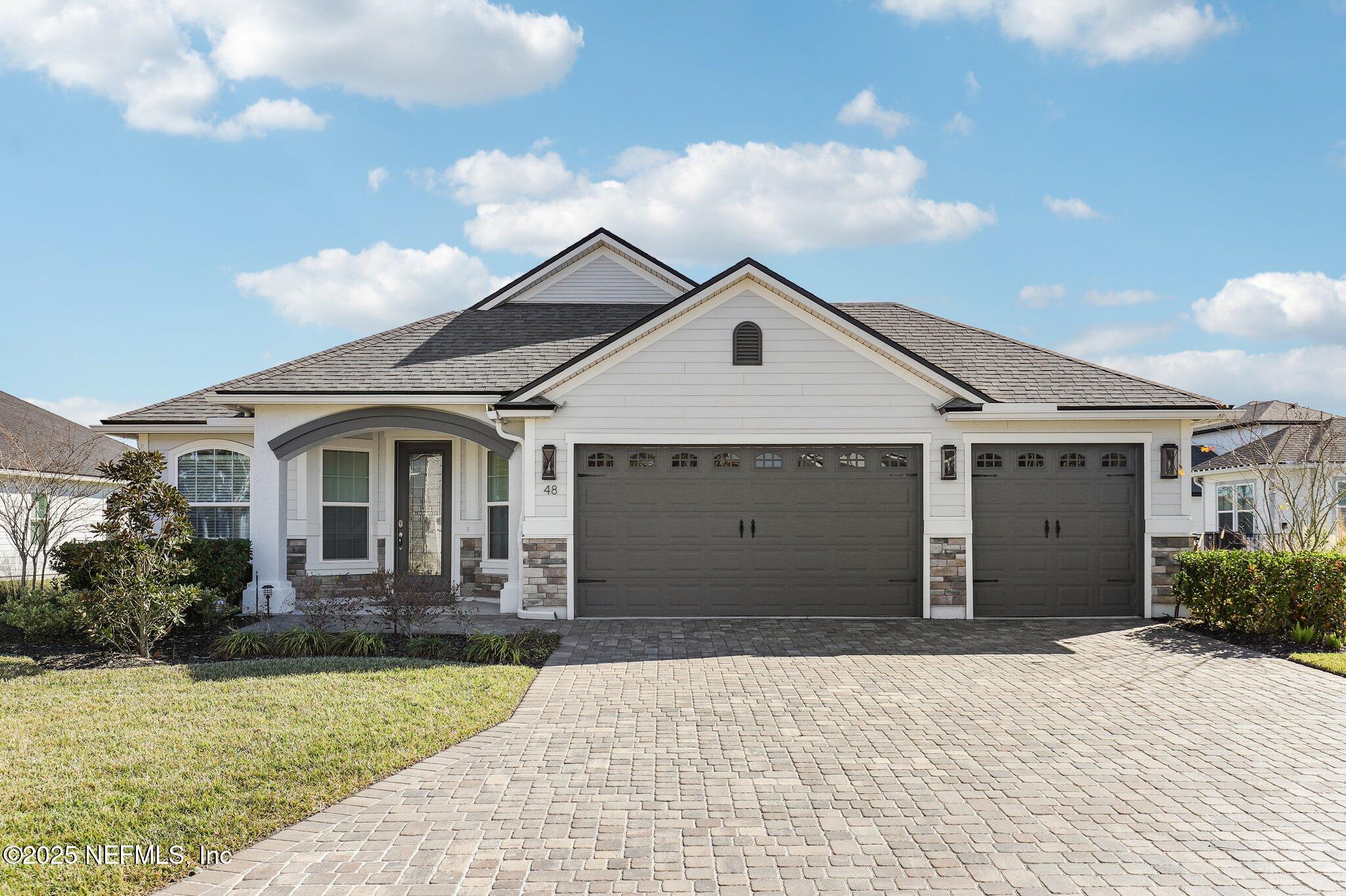 48 Fawn Field Lane St. Augustine, FL 32092 - Photo 2 of 73 a front view of a house with a yard and garage