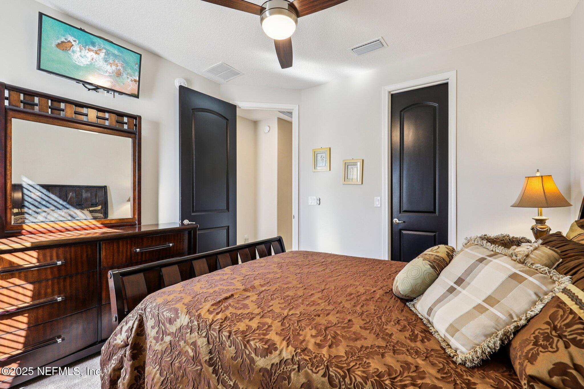 48 Fawn Field Lane St. Augustine, FL 32092 - Photo 30 of 73 a bedroom with a bed and a dresser