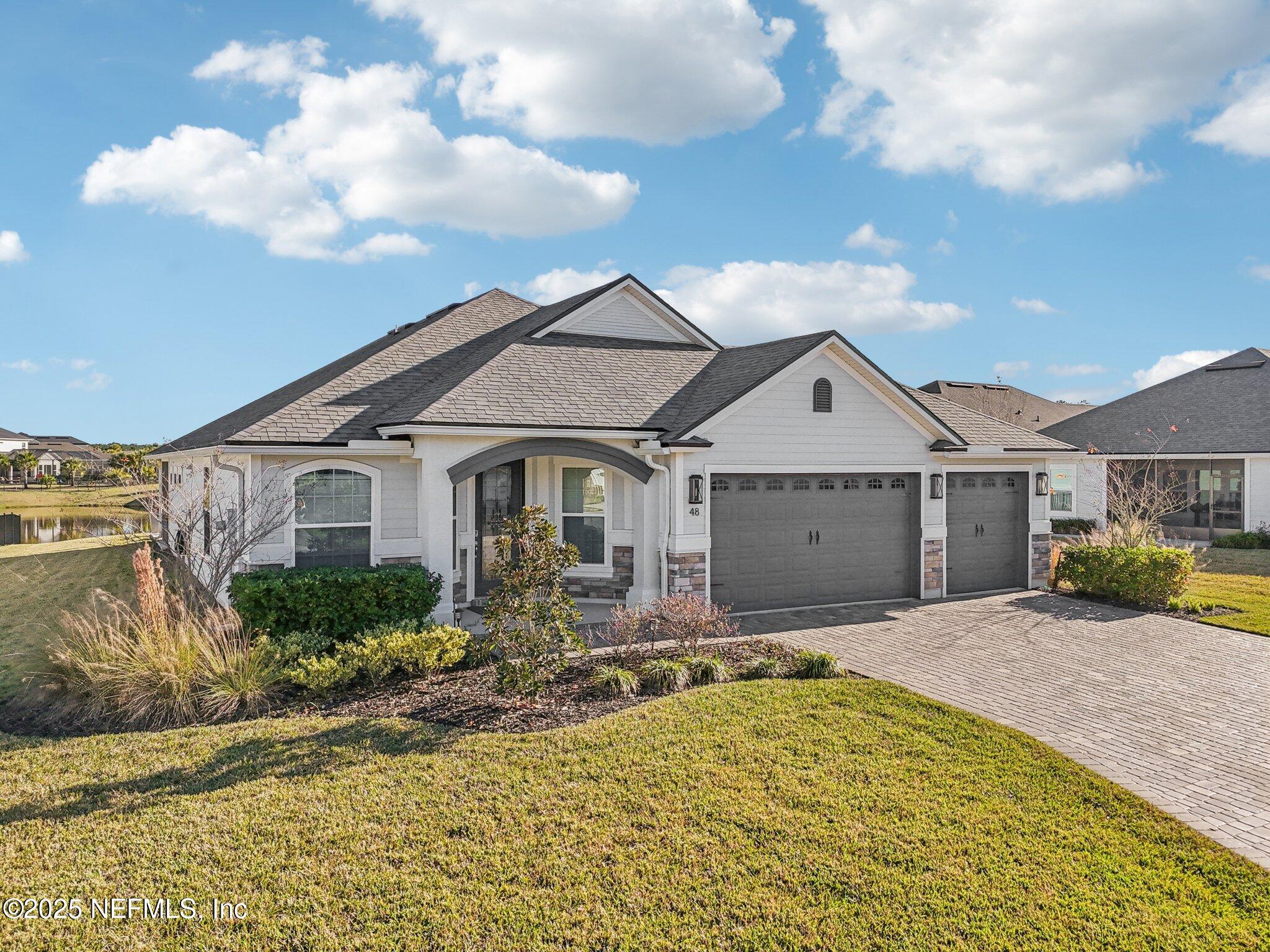 48 Fawn Field Lane St. Augustine, FL 32092 - Photo 42 of 73 a front view of a house with a yard and garage