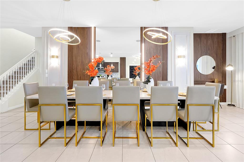 4494 Kaipo Road Davenport, FL 33897 - Photo 17 of 100 a dining room with wooden floor a glass table and chairs
